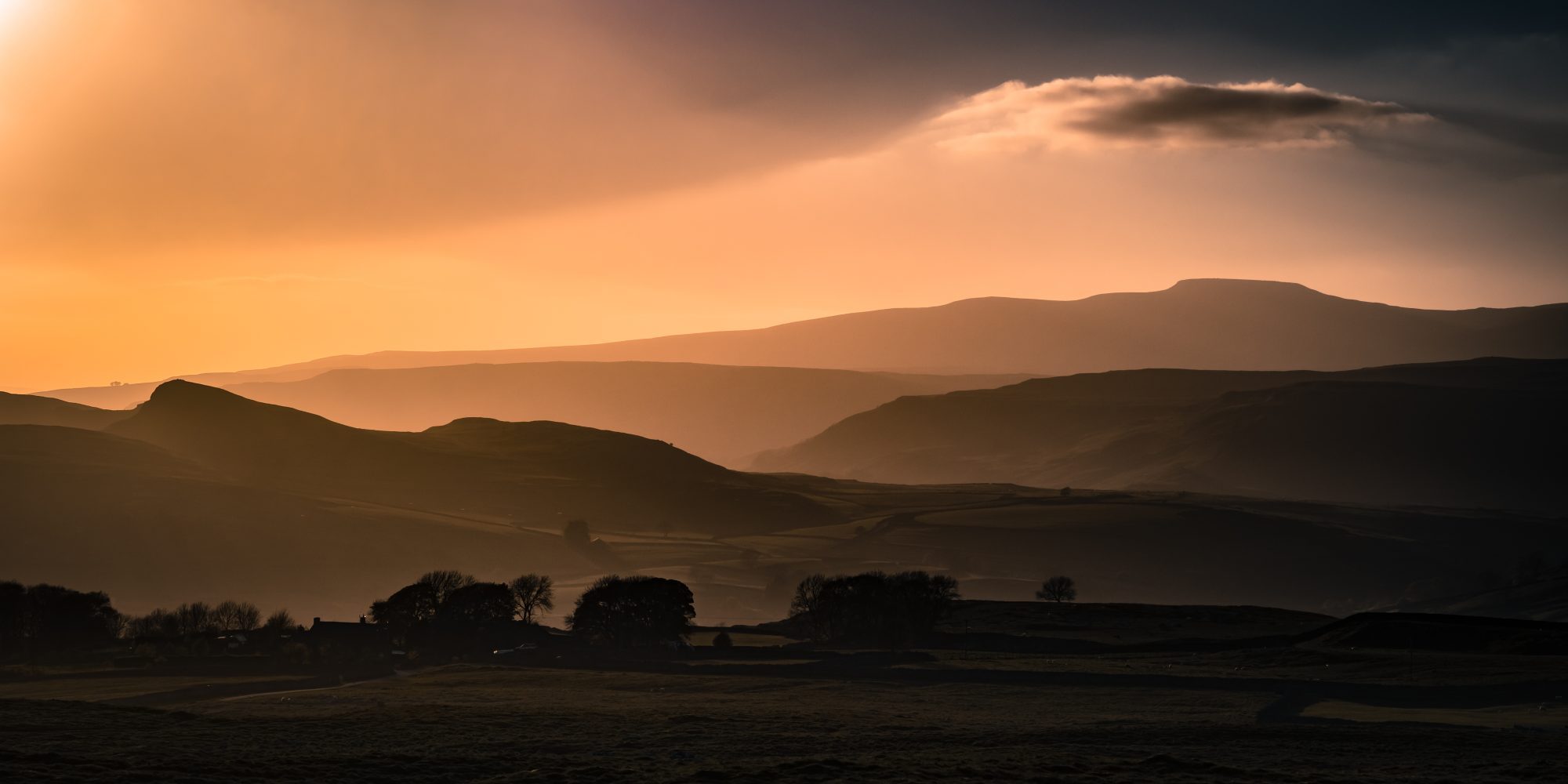 sunset cloudy view across to ingleborough